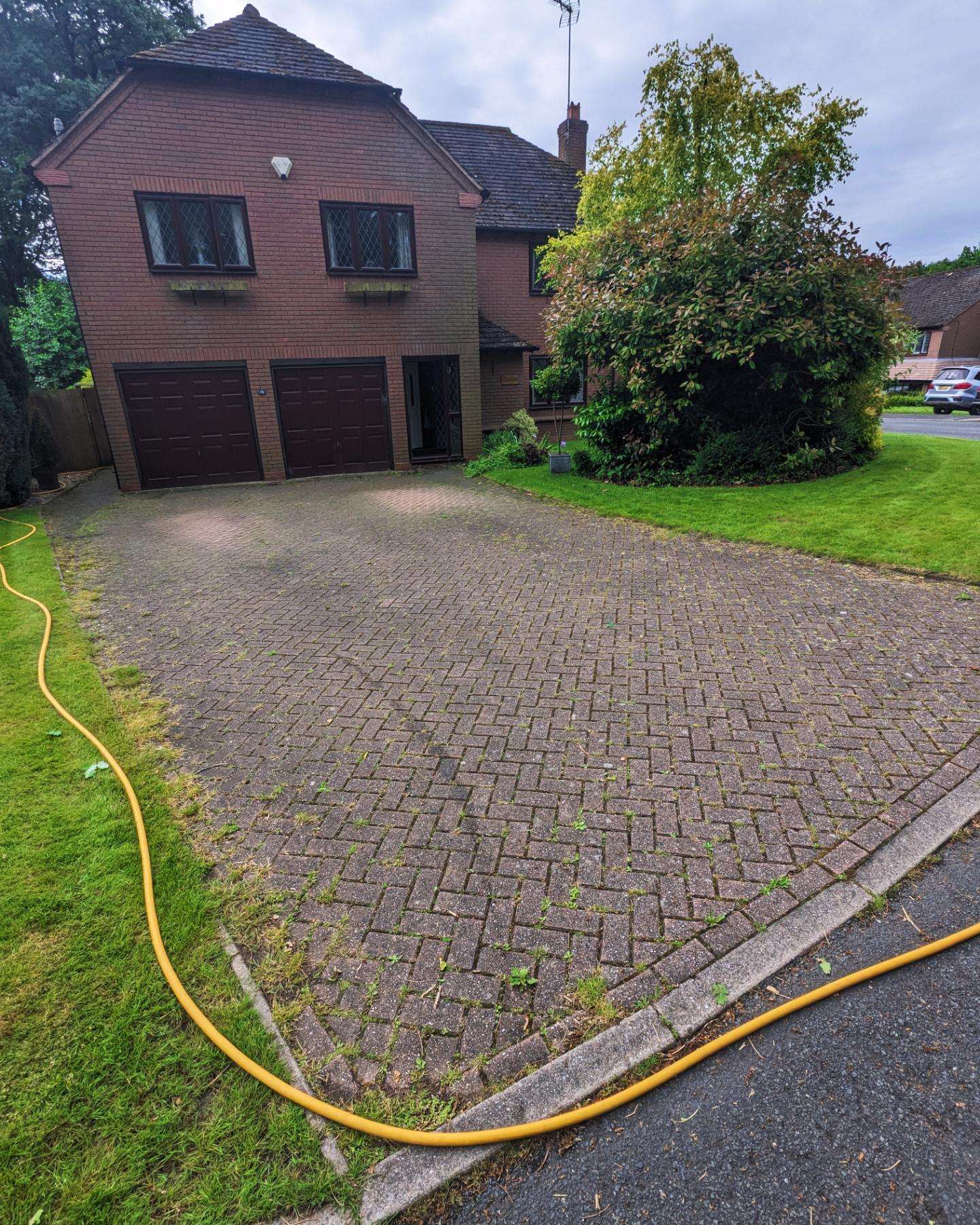 Block paving before jet washing - weathered and mossy